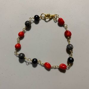 Bracelet, hand made by me, black and red seeds